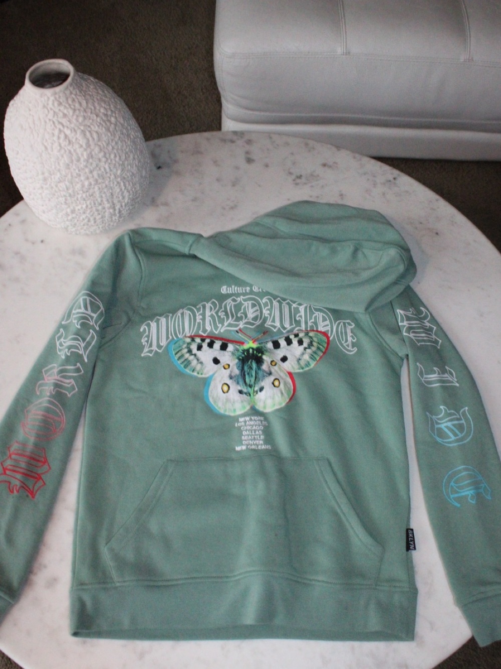 Green hoodie with butterfly graphic